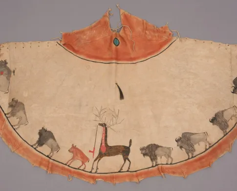 A photograph of a tipi model with bison and elk depictions drawn on it