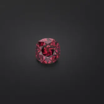 Red diamond gem on a black background